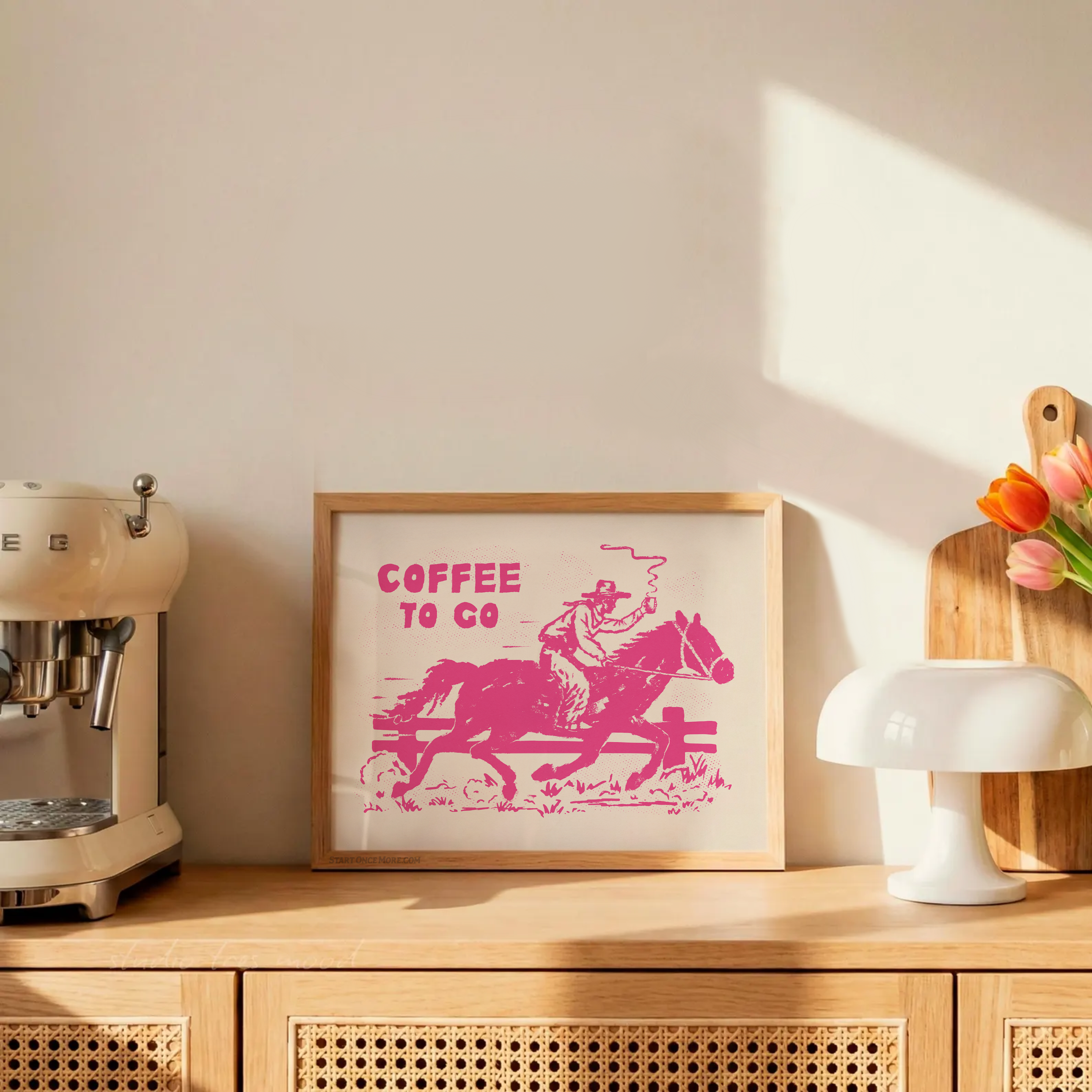 Framed artwork with 'Coffee to Go' text and horse graphic on a wooden shelf with coffee machine and tulips.