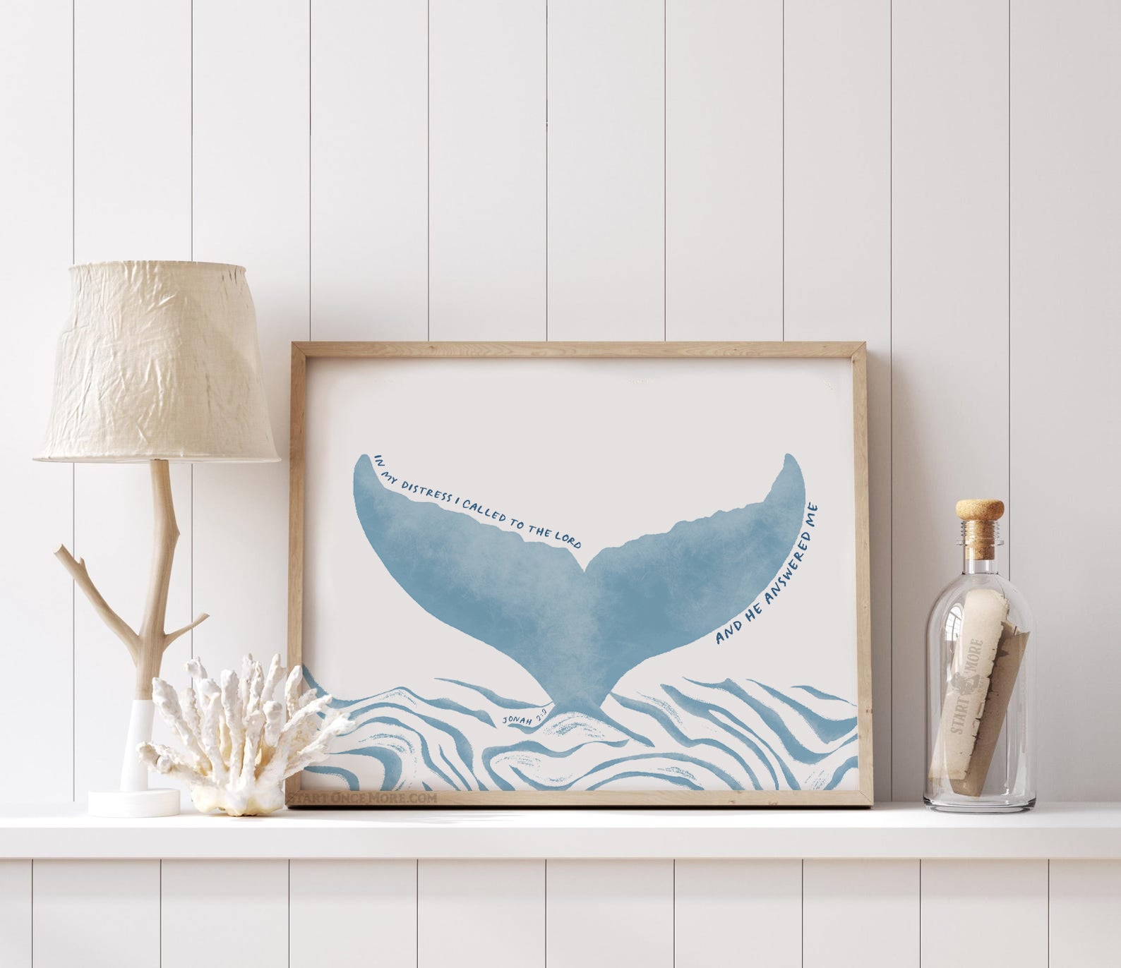 Jonah 2 2 bible verse art print with light blue whale tail illustration on textured cream cotton paper styled in a beachy home